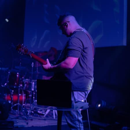Erik playing guitar on stage, live show